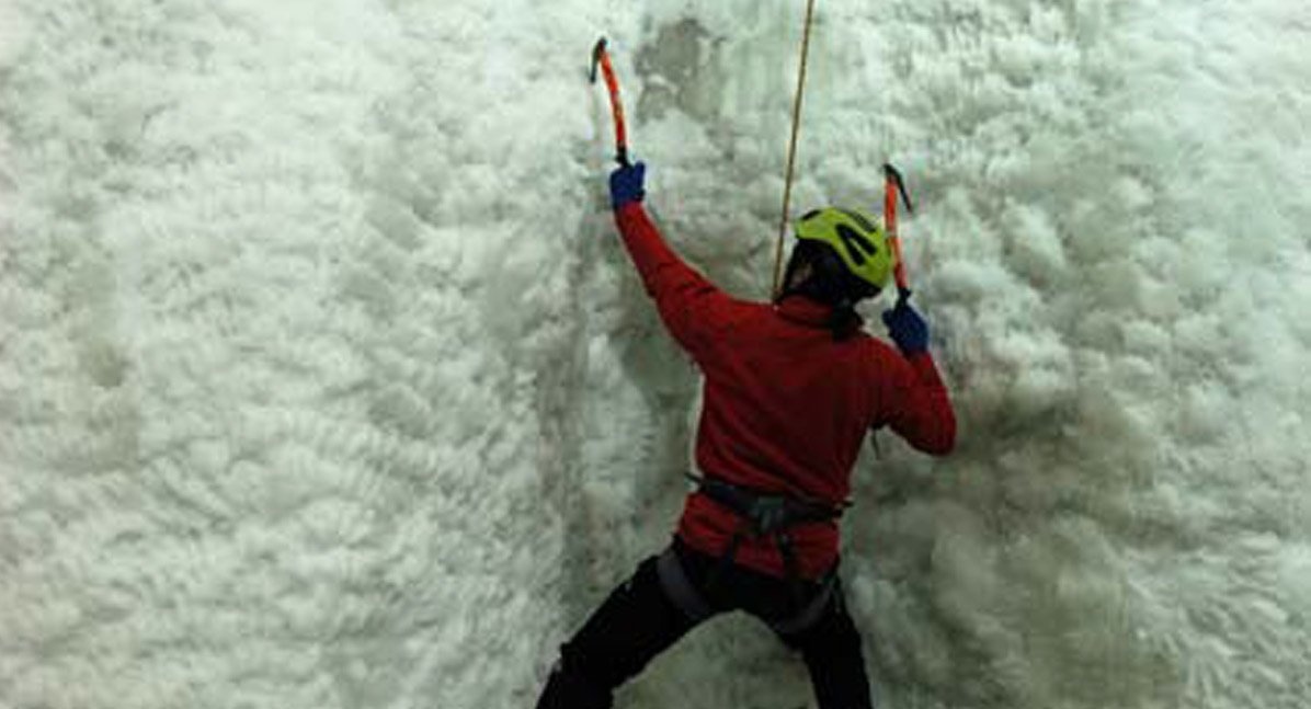 man climbing an ice wall